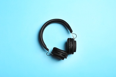 Photo of Stylish headphones on color background, top view