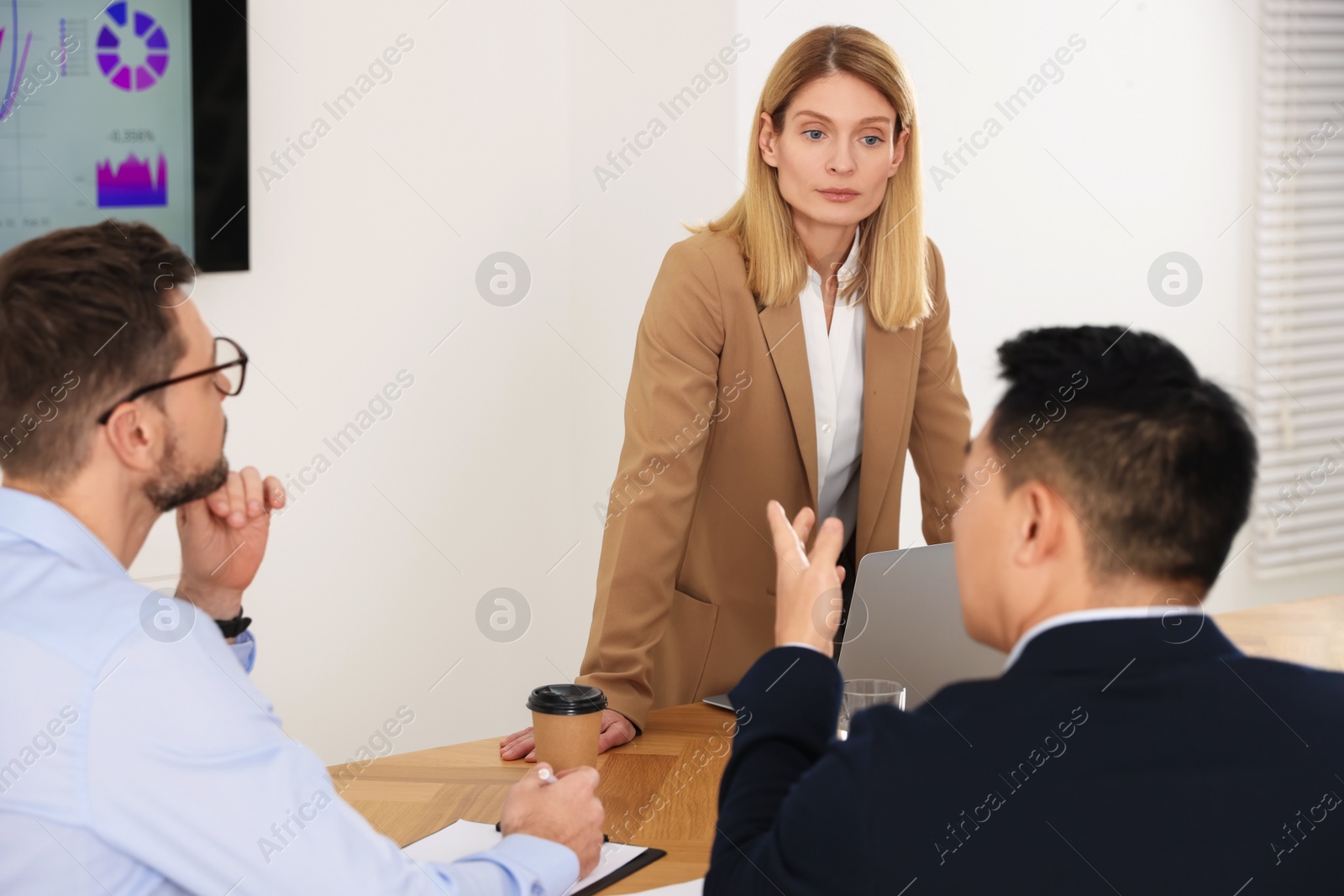 Photo of Businesswoman having meeting with her employees in office