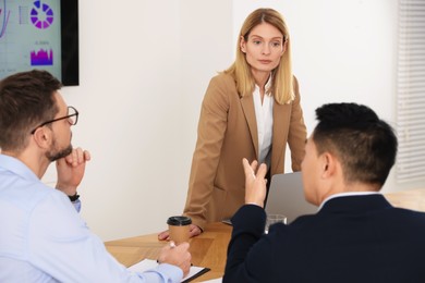 Photo of Businesswoman having meeting with her employees in office