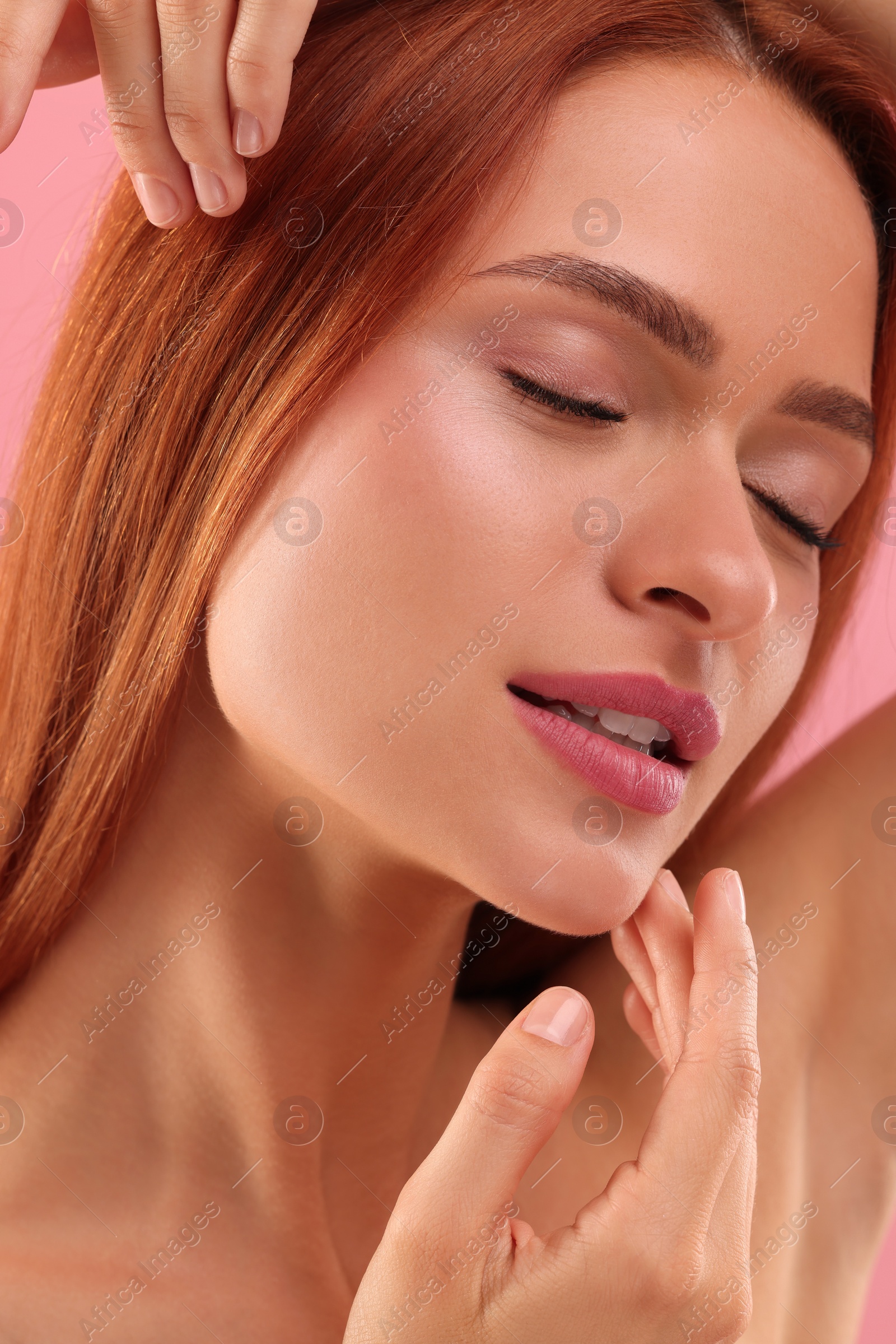 Photo of Portrait of beautiful young woman on pink background, closeup