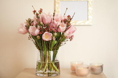 Beautiful bouquet with spring pink tulips on table