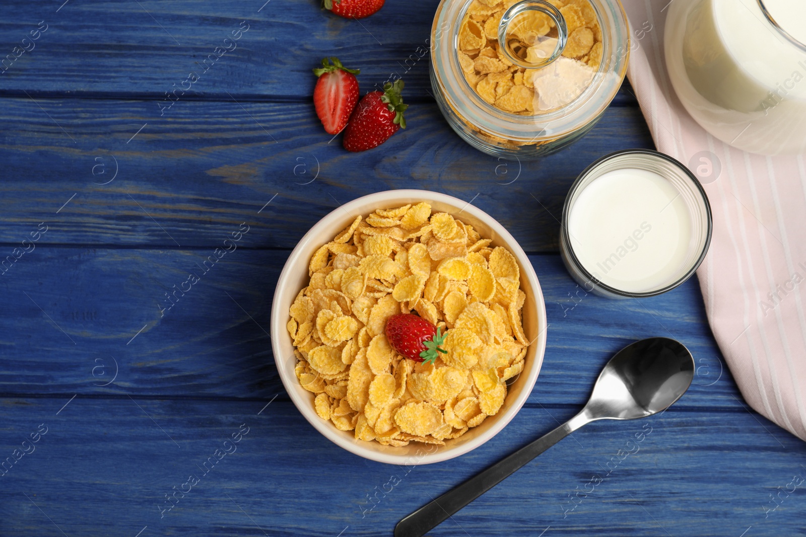 Photo of Flat lay composition with healthy cornflakes in bowl on wooden table