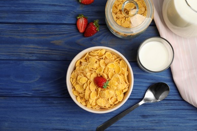 Photo of Flat lay composition with healthy cornflakes in bowl on wooden table