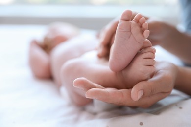 Photo of Mother and her newborn baby on bed, closeup. Space for text