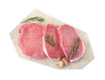 Photo of Board with pieces of raw pork meat, rosemary and garlic isolated on white, top view