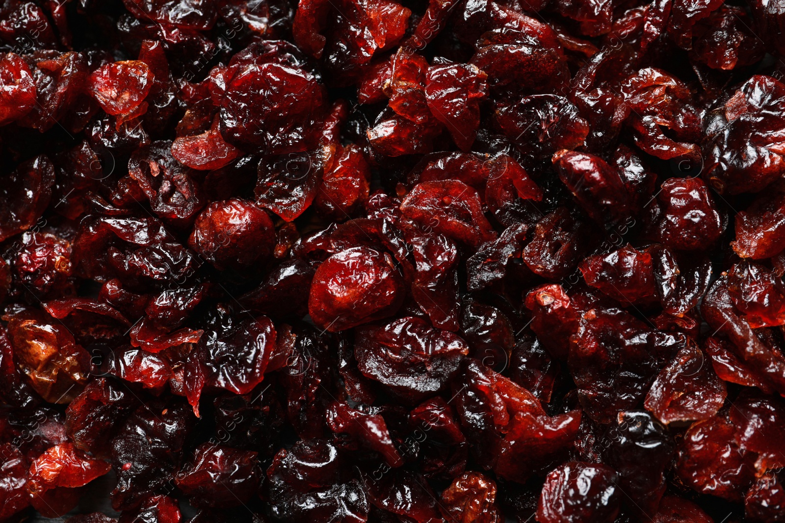 Photo of Tasty cranberries as background, top view. Dried fruits as healthy snack