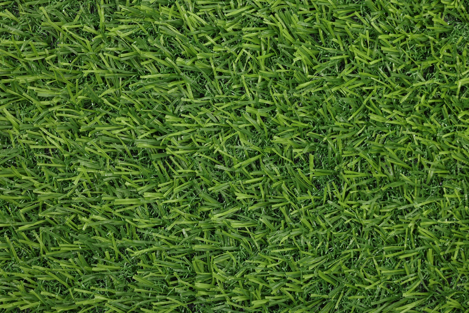 Photo of Green artificial grass as background, top view