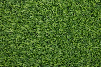 Photo of Green artificial grass as background, top view