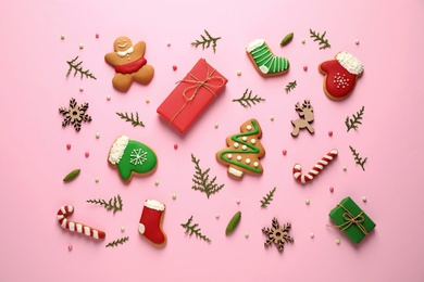 Flat lay composition with Christmas decorations on pink background