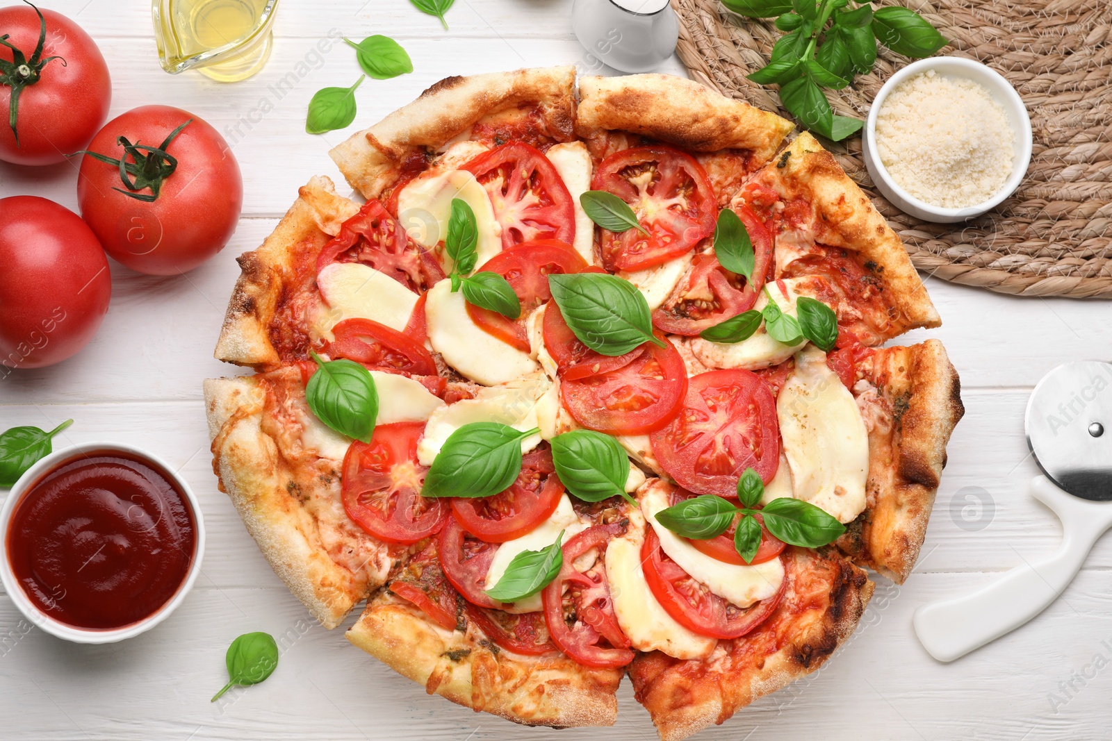 Photo of Delicious Caprese pizza on white wooden table, flat lay