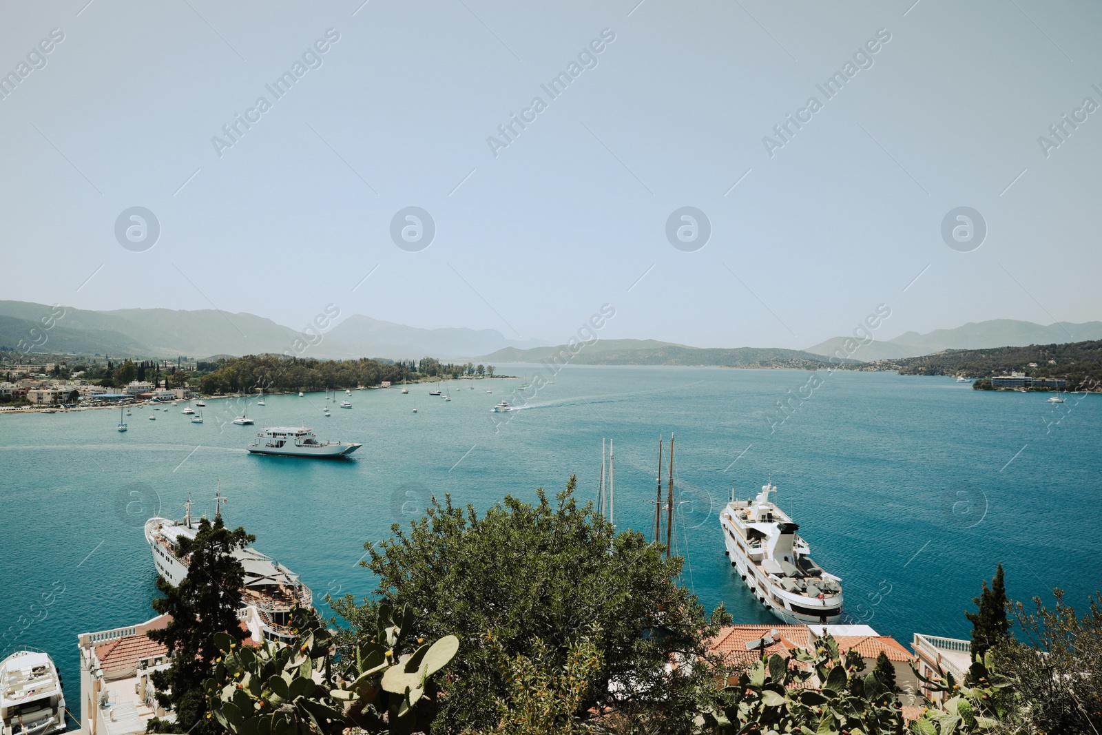 Photo of Beautiful view of coastal city with boats on sunny day