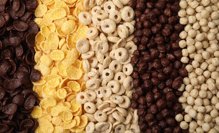 Photo of Different types of breakfast cereals as background, top view