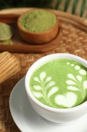Photo of Delicious matcha latte in cup on table