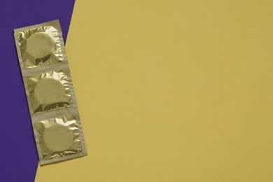 Photo of Condom packages on color background, flat lay and space for text. Safe sex