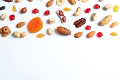 Photo of Flat lay composition of different dried fruits and nuts on white background. Space for text