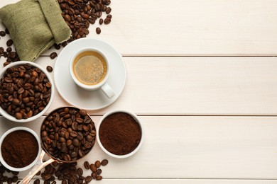 Coffee beans, powder and cup of drink on white wooden table, flat lay. Space for text