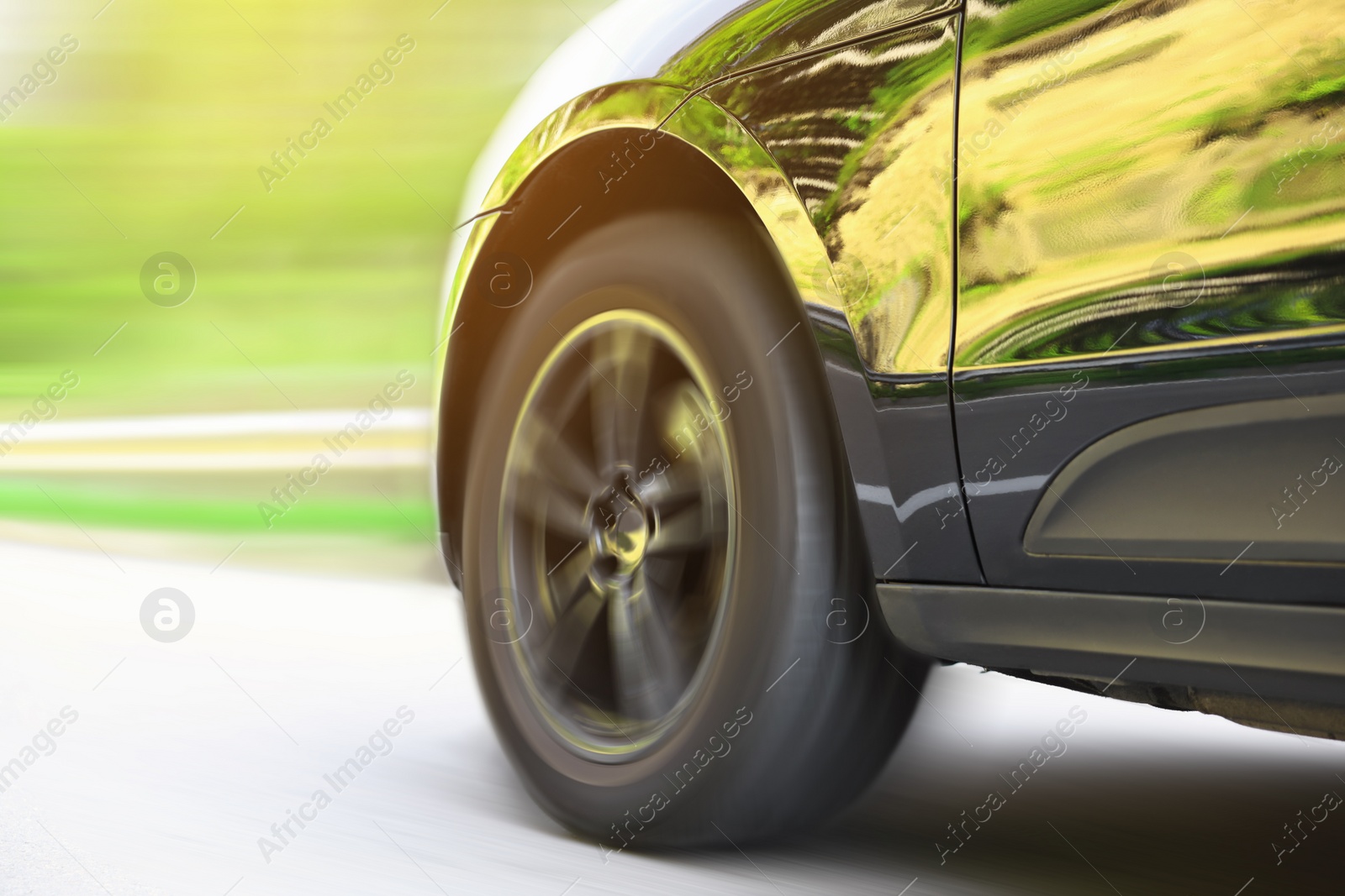 Image of Black car driving on road outdoors, closeup with motion blur effect. Space for text