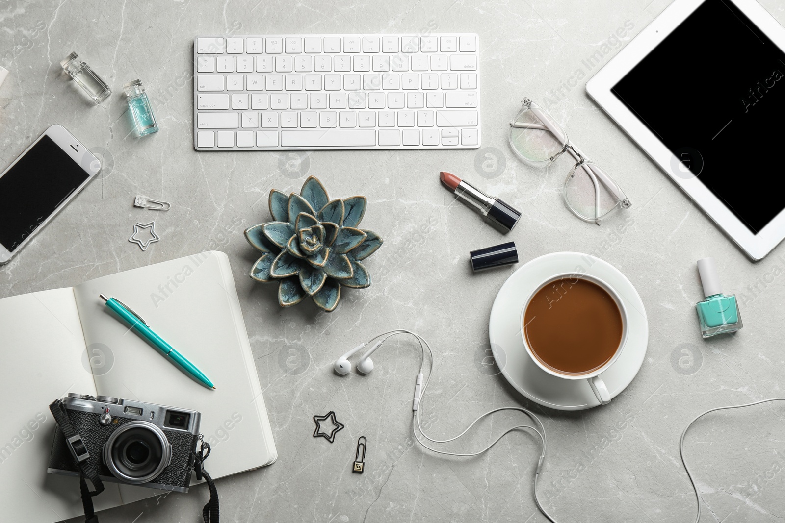 Photo of Blogger's workplace with coffee, tablet and different stuff on table, flat lay