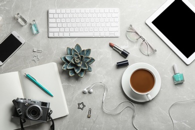 Blogger's workplace with coffee, tablet and different stuff on table, flat lay