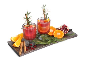 Photo of Christmas Sangria cocktail in glasses, ingredients and fir tree branches isolated on white