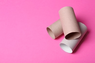 Photo of Empty toilet paper rolls and space for text on color background