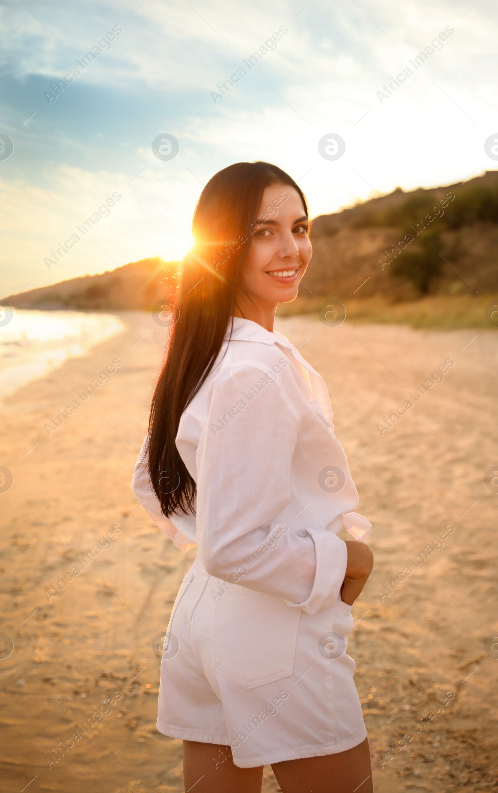 Photo of Young beautiful woman on beach at sunset