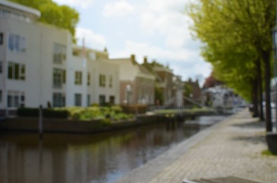 Photo of Blurred view of buildings along canal on sunny day