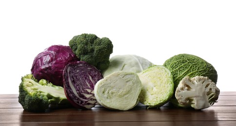 Photo of Different types of cabbage on wooden table against white background