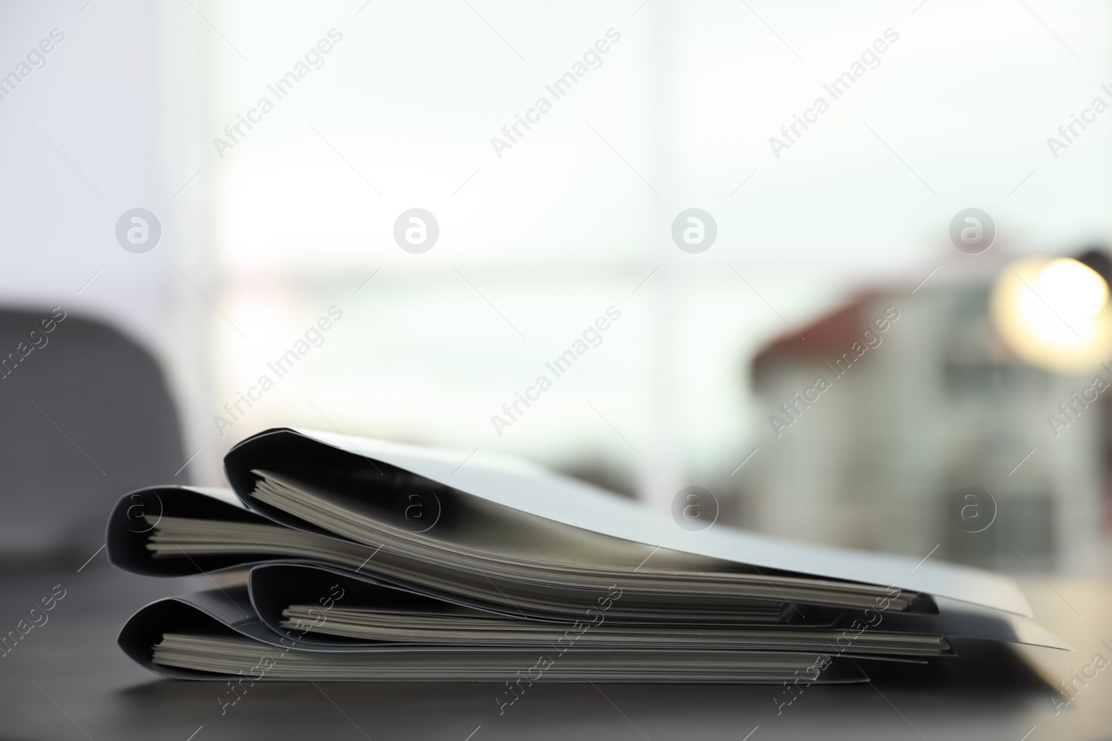 Photo of Stack of folders with documents on office table. Space for text