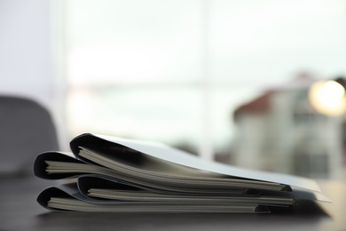 Photo of Stack of folders with documents on office table. Space for text