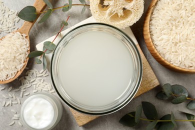 Flat lay composition with natural rice water on light grey table