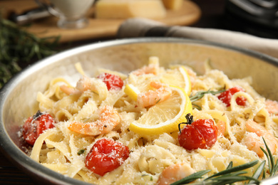 Delicious pasta with shrimps on table, closeup