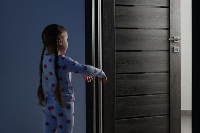 Photo of Girl in pajamas sleepwalking indoors at night