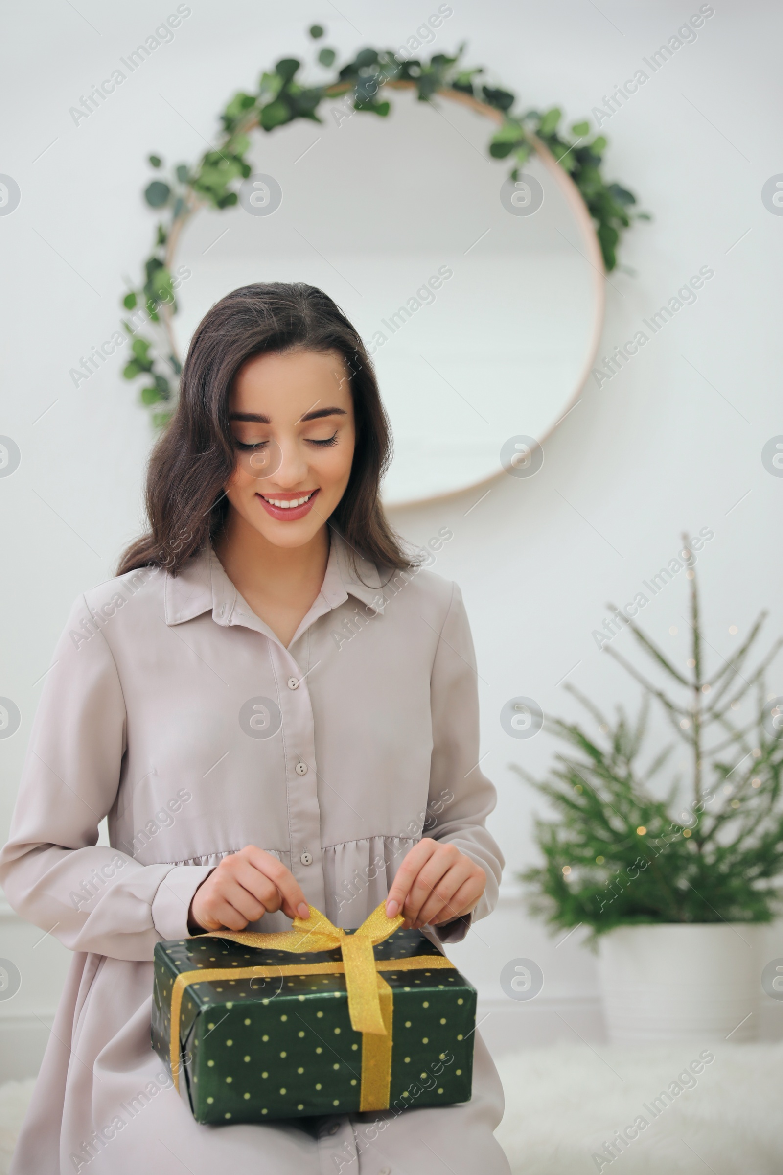 Photo of Woman with gift box on floor at home