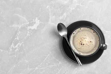 Photo of Cup of aromatic hot coffee on marble background, top view