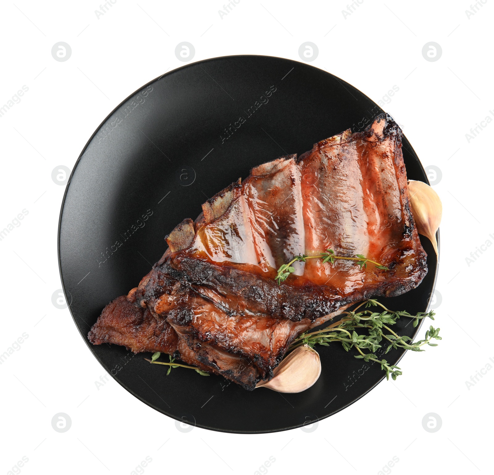 Photo of Tasty grilled ribs with thyme and garlic isolated on white, top view