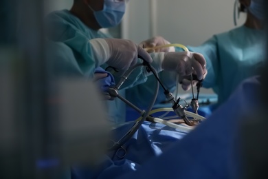 Medical team performing surgery in operating room, closeup