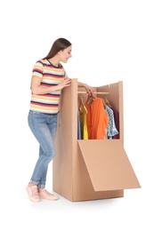 Photo of Young woman near wardrobe box on white background