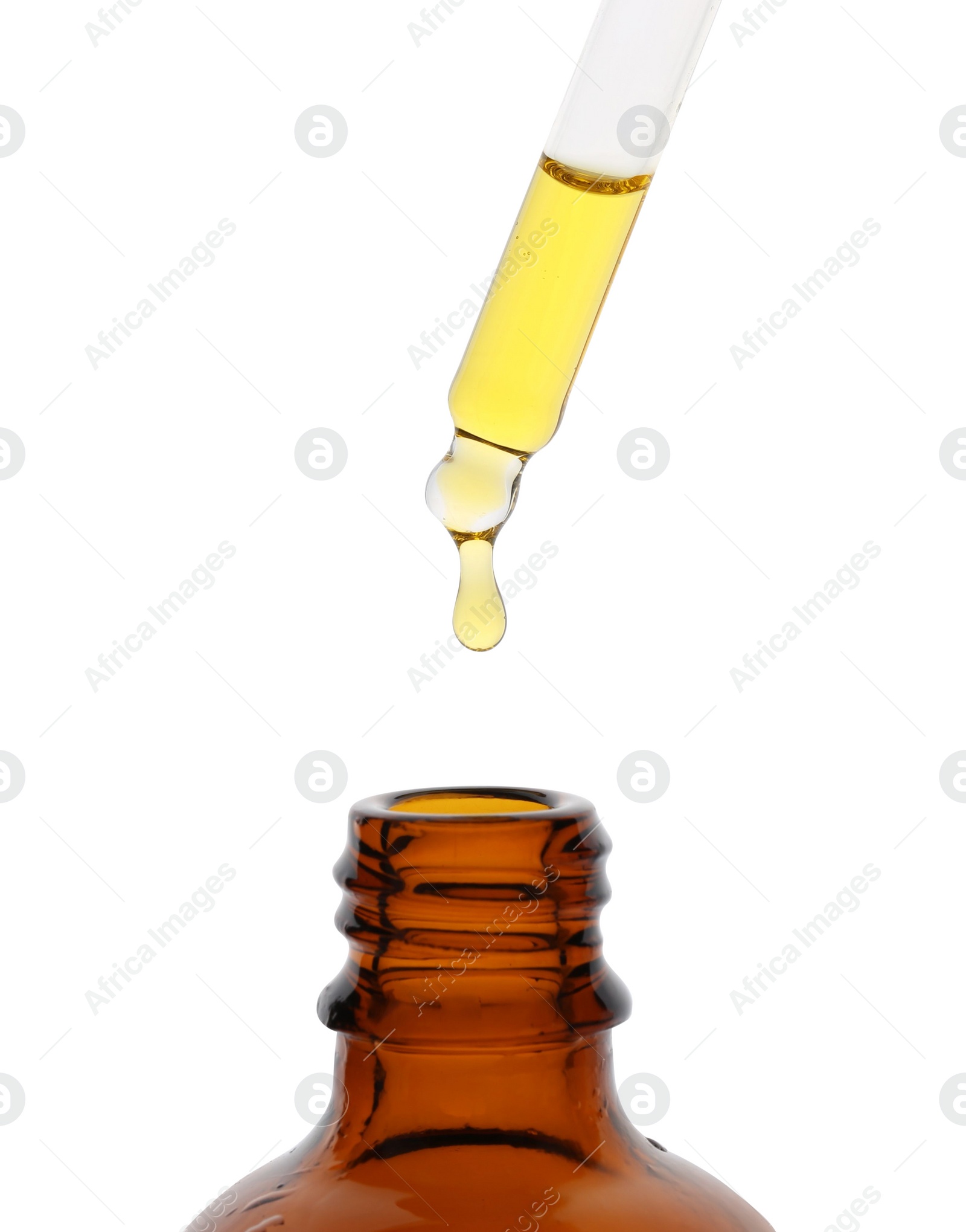 Photo of Dripping tincture from pipette into bottle isolated on white