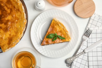 Photo of Delicious pie with minced meat on white wooden table, flat lay