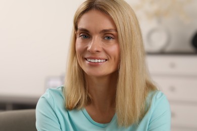 Photo of Portrait of beautiful woman with blonde hair. Attractive lady smiling and looking into camera