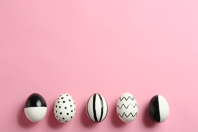 Photo of Painted Easter eggs on color background, flat lay with space for text