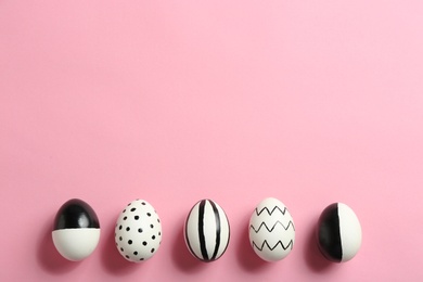 Painted Easter eggs on color background, flat lay with space for text