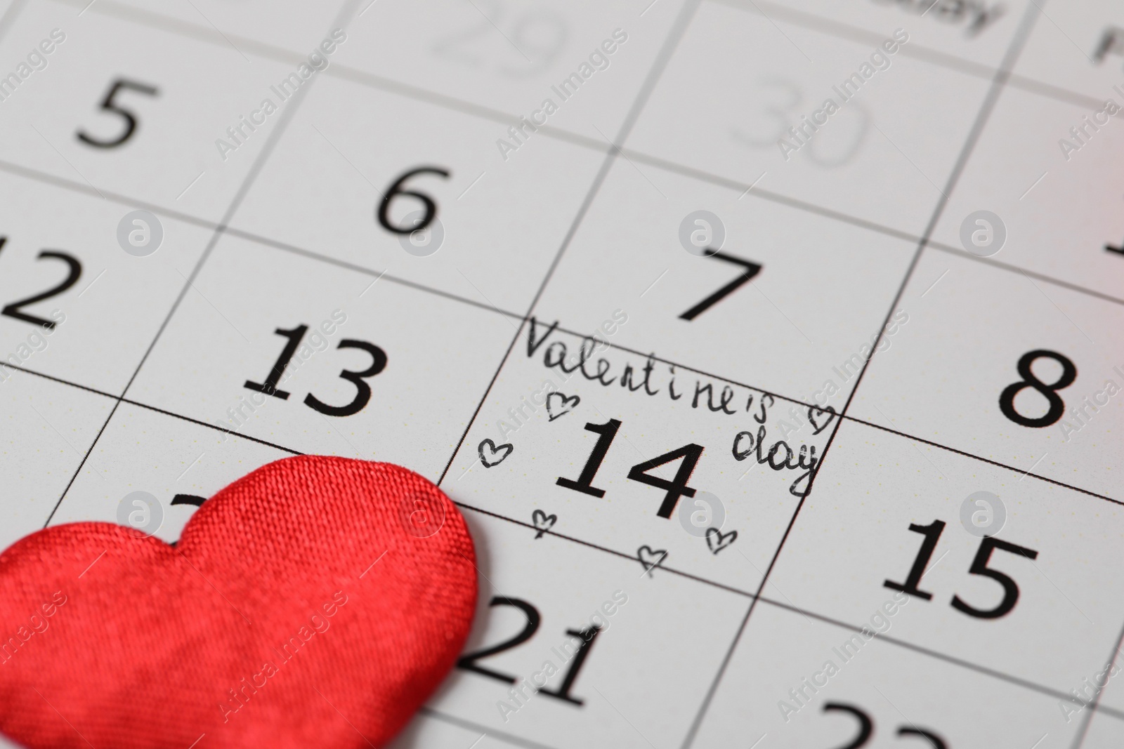 Photo of Calendar with marked Valentine's Day and red heart, closeup
