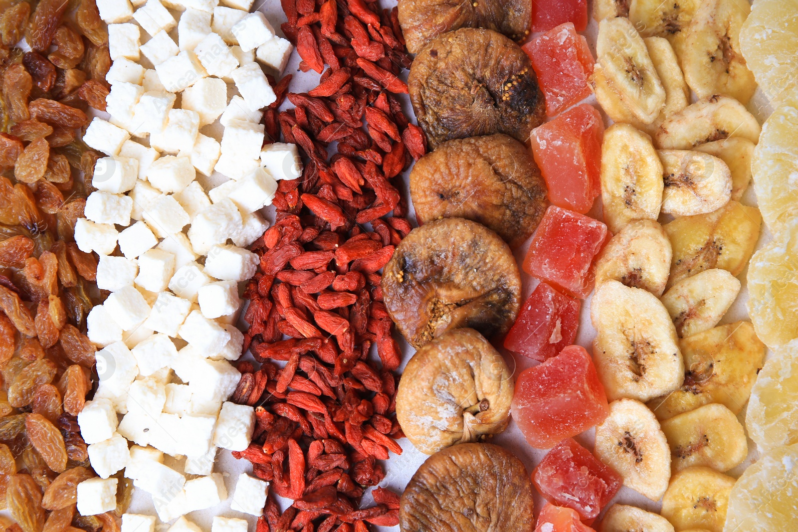 Photo of Different tasty dried fruits as background, top view