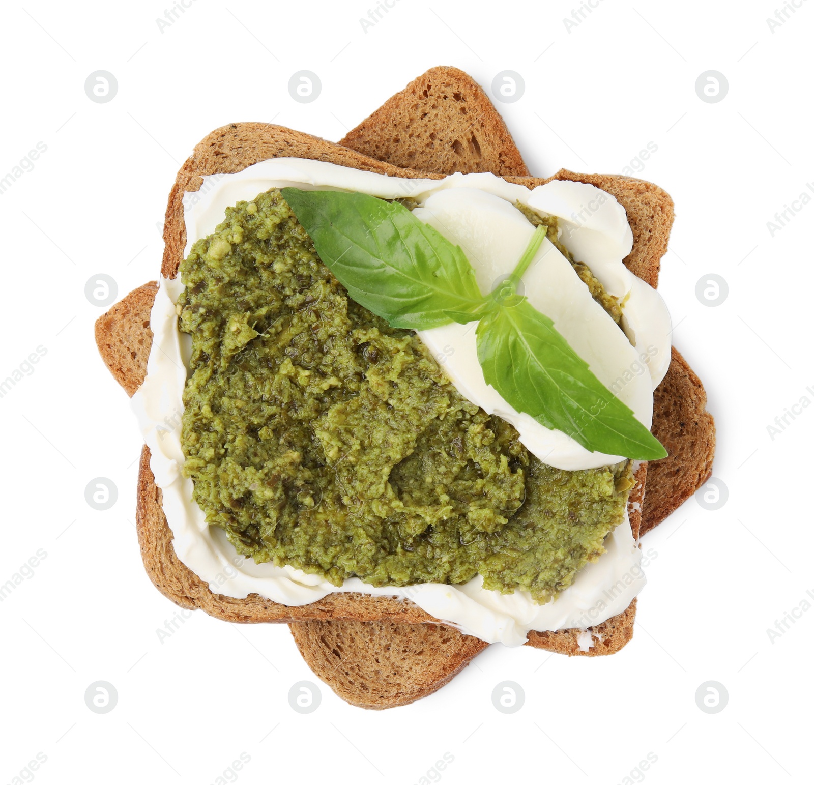 Photo of Tasty bruschetta with cream cheese, pesto sauce and fresh basil on white background, top view