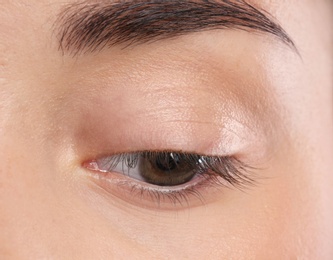 Photo of Young woman with beautiful natural eyelashes, closeup view