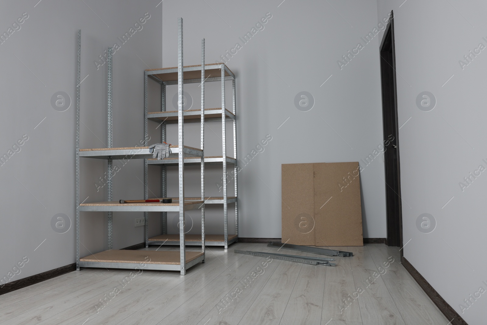 Photo of Office room with white walls and metal storage shelves