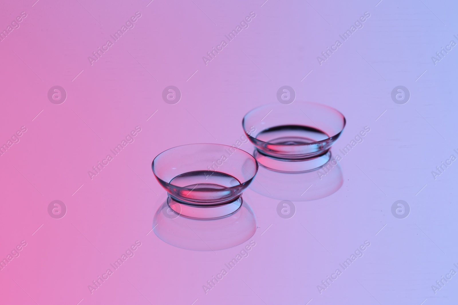 Photo of Pair of contact lenses on mirror surface