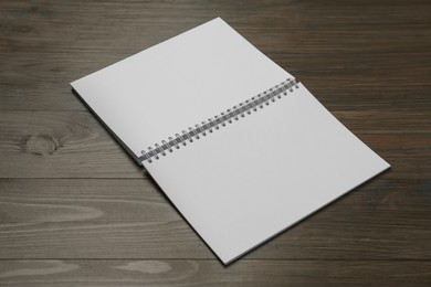 Photo of Blank paper brochure on wooden table. Mockup for design